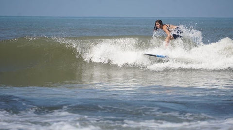 surfing woman in goa india