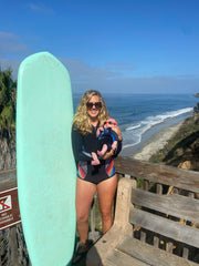 Jenny surfing with her baby