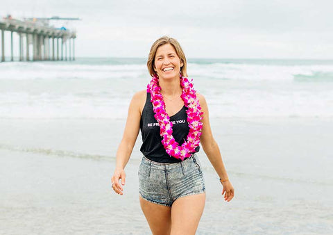 Jessica with the lei walking on the beach near scripps pier