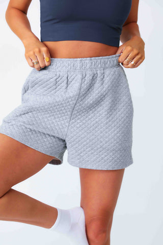 Model wearing Gray Lounge Shorts with Diamond Quilting Detailing.