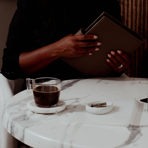 An image of Cloth & Paper founder, Ashley Reynolds, using her Cortado Foundations Agenda while enjoying her coffee.