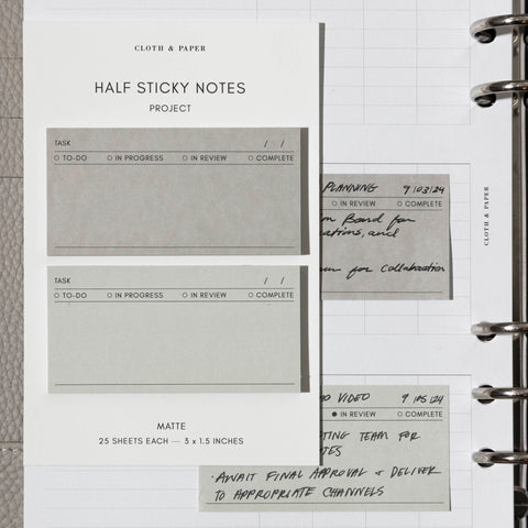 A minimalist image of a planner adorned with colorful Project Half Sticky Notes, each bearing handwritten tasks.