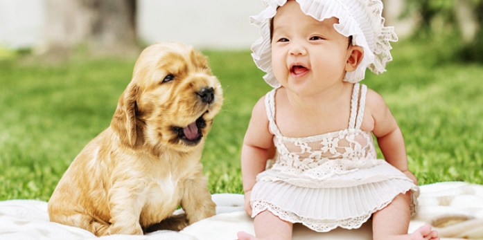 A baby girl with a baby dog.