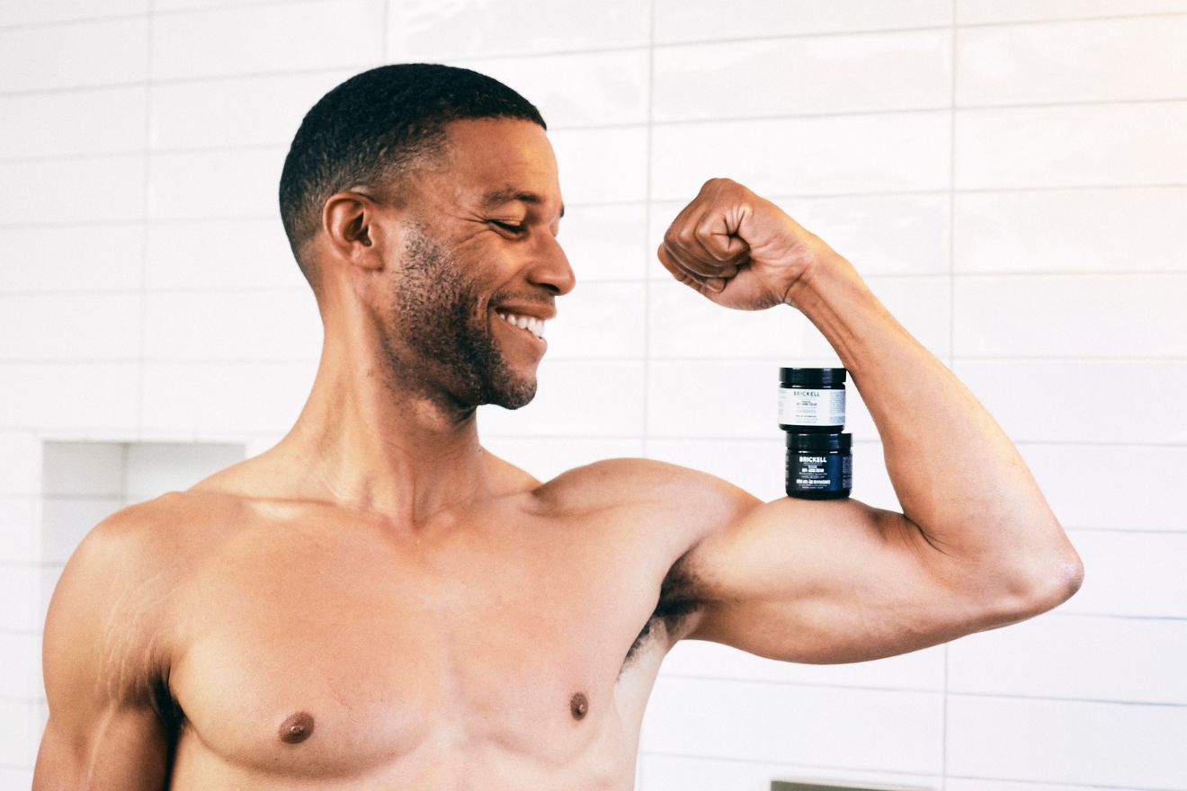 Man flexing with skincare products