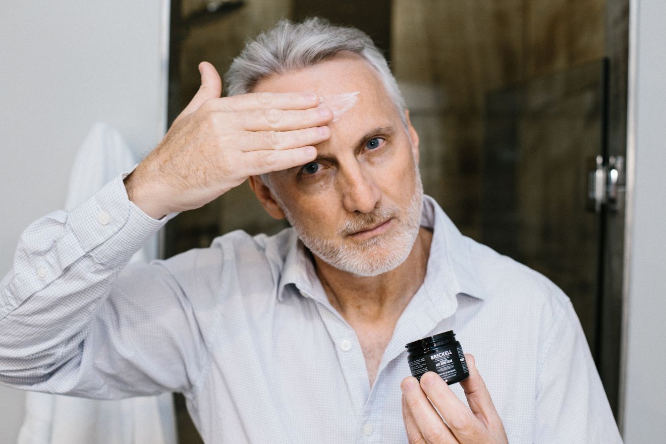 Man applying anti-aging cream