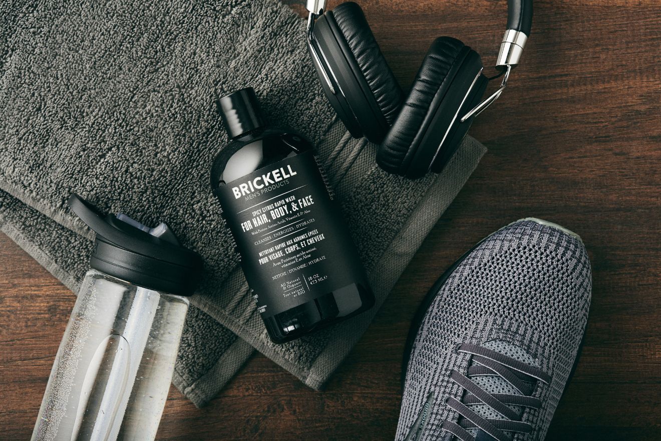 Skincare product beside gym essentials