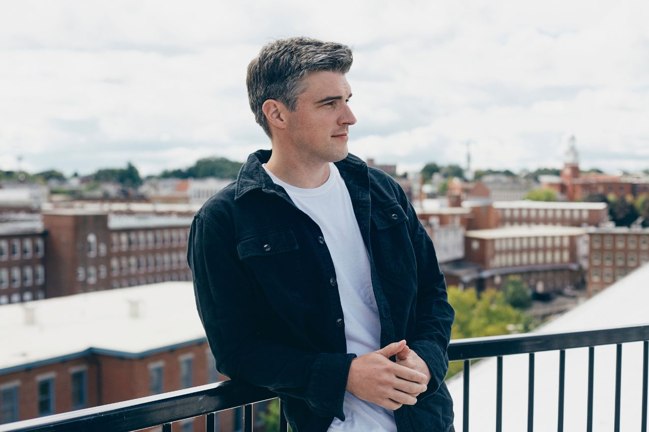 man standing on rooftop