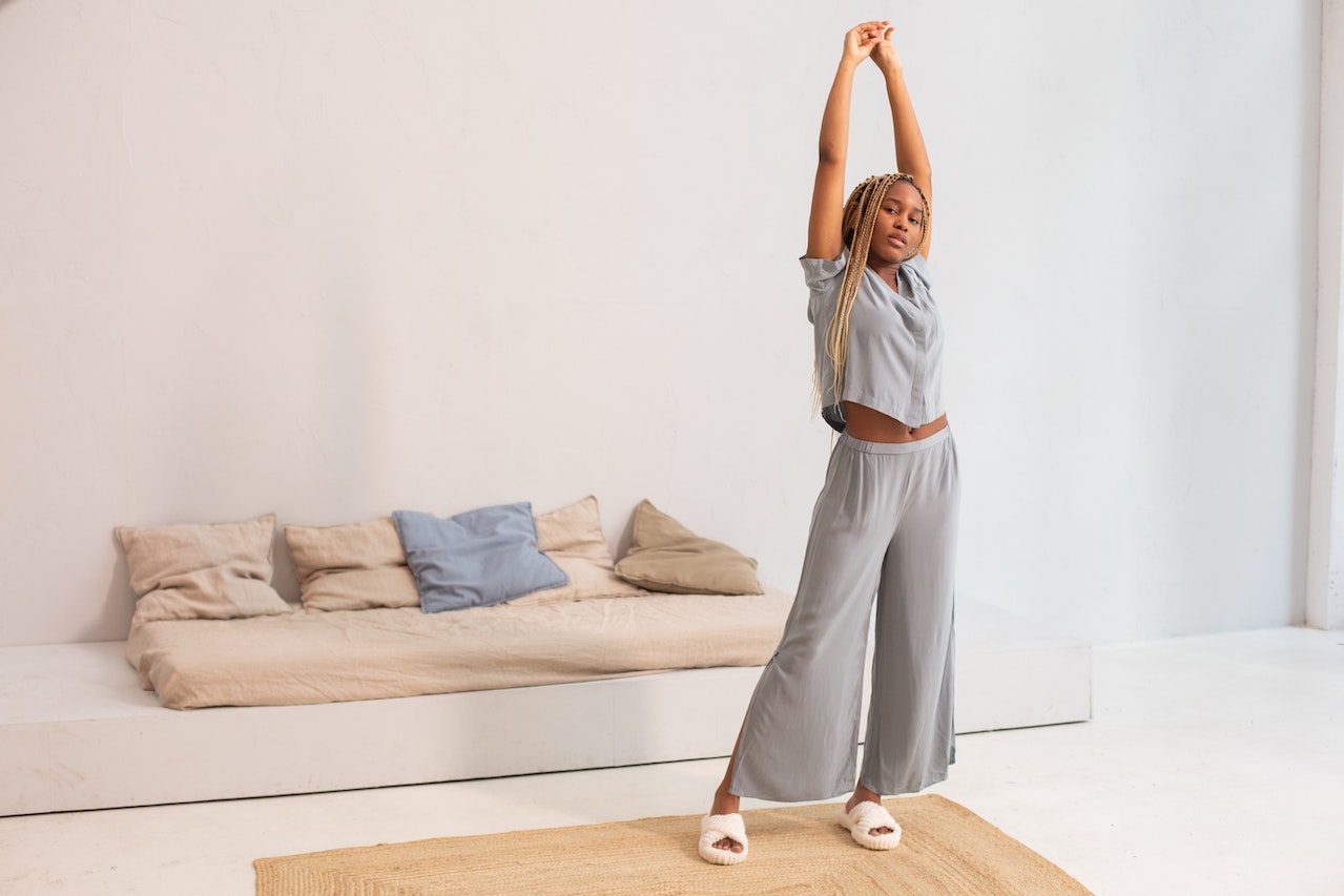 A young woman raising and stretching her arms