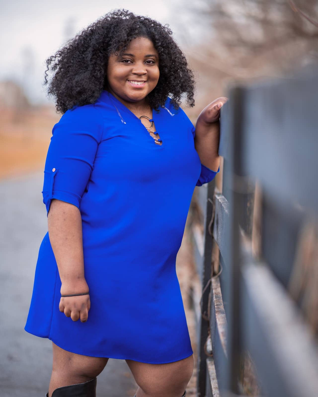 A woman wearing a blue v-neck t-shirt dress