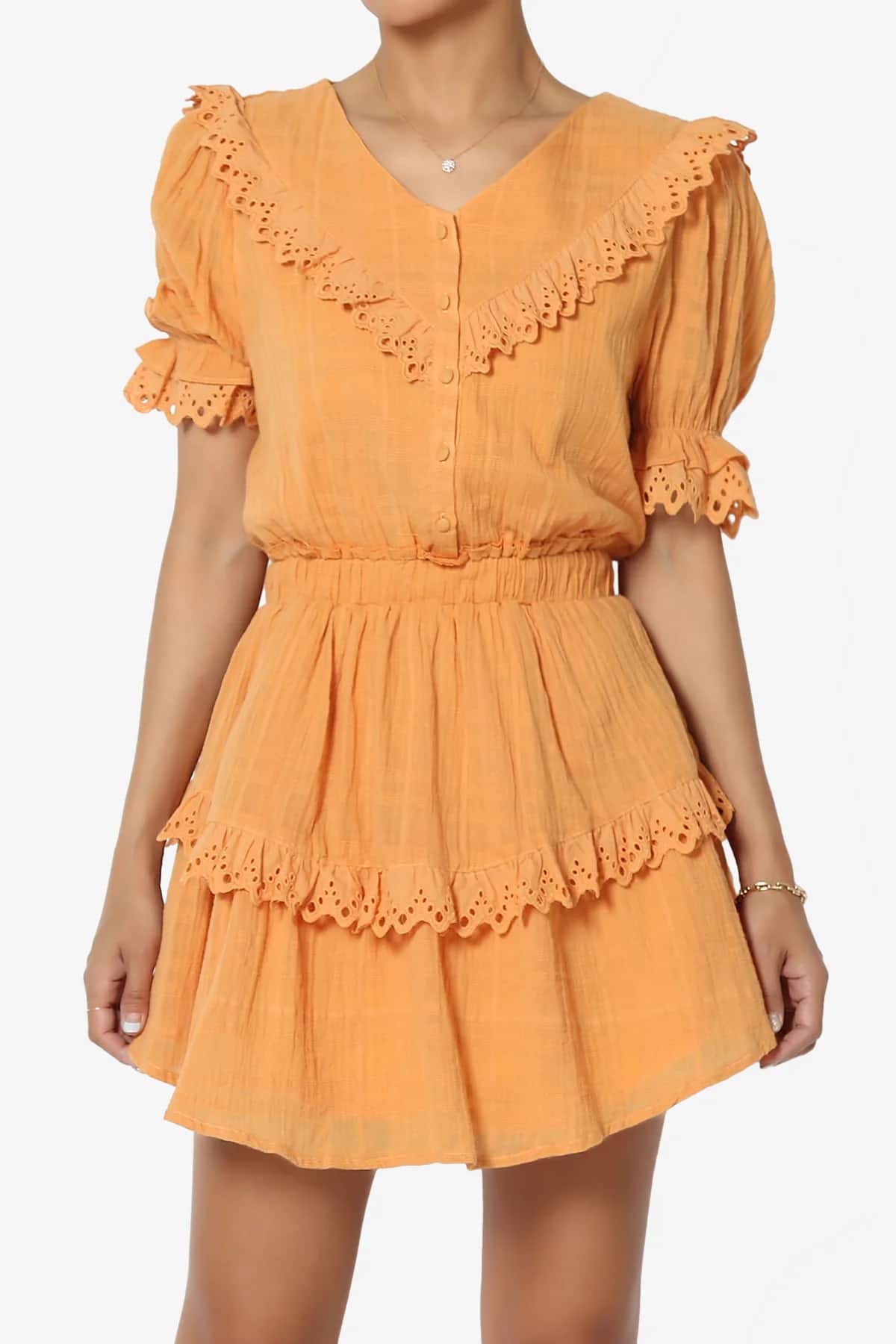 A woman wearing a short orange dress