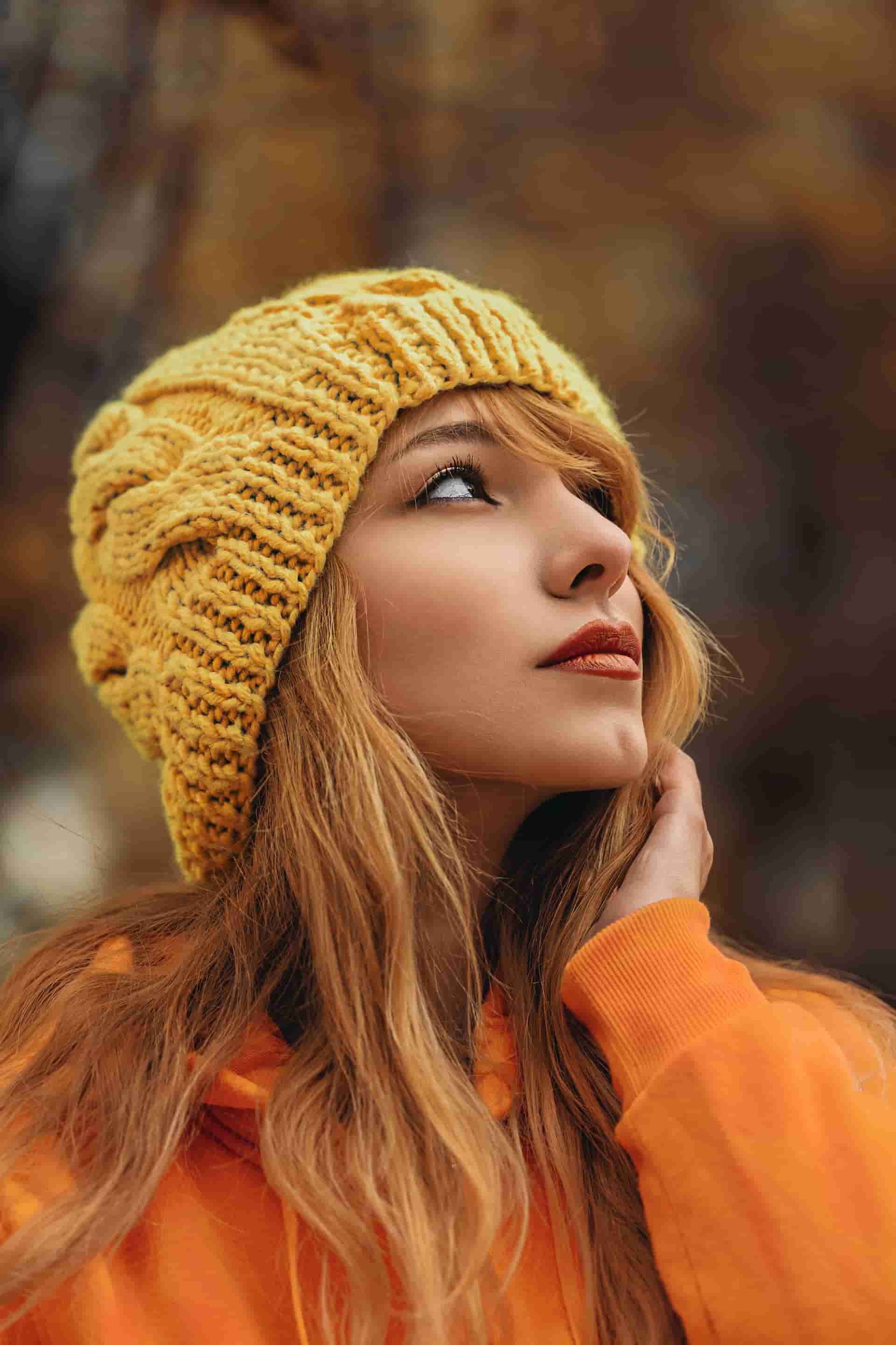 A woman wearing a yellow beanie hat
