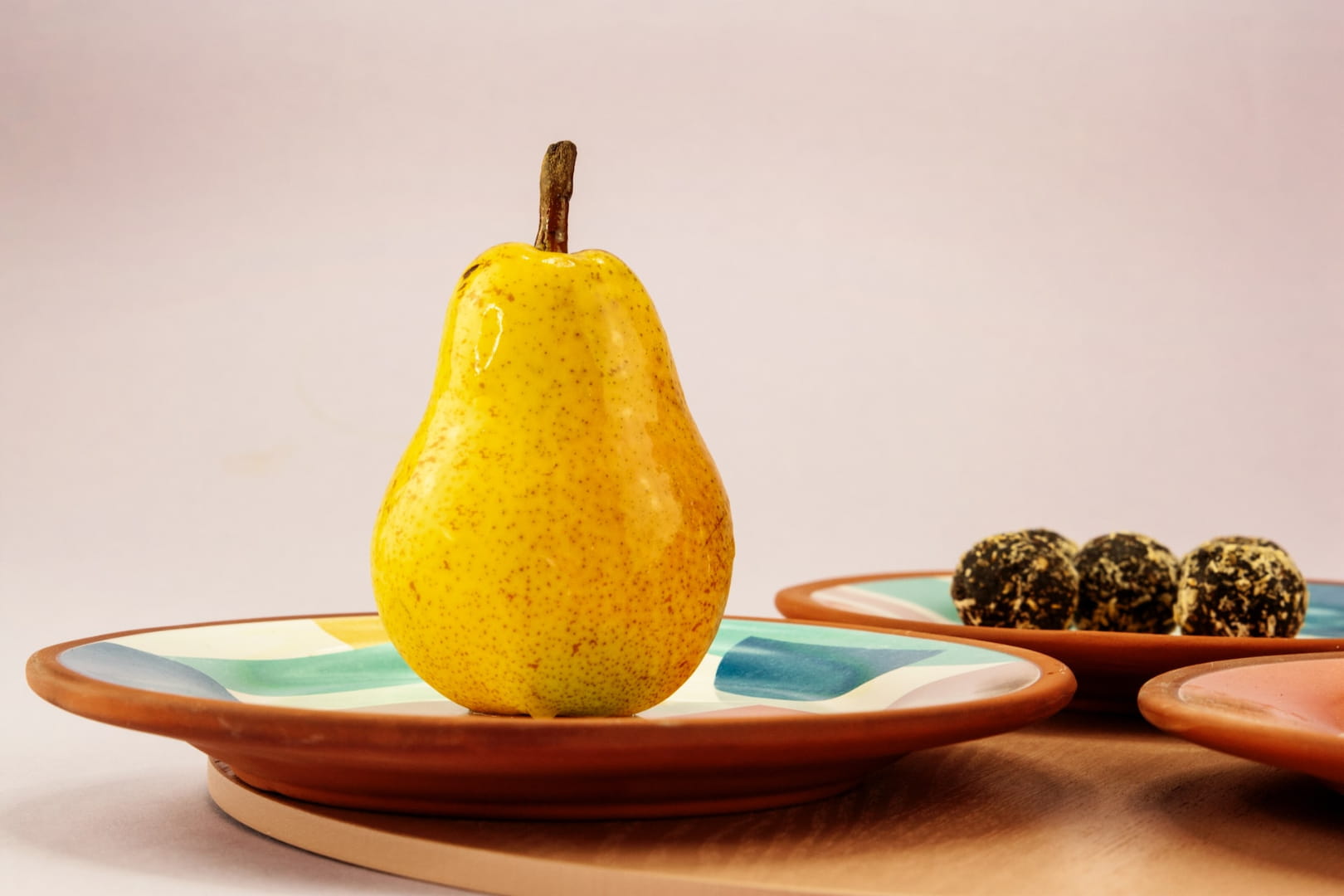 A yellow pear on a plate