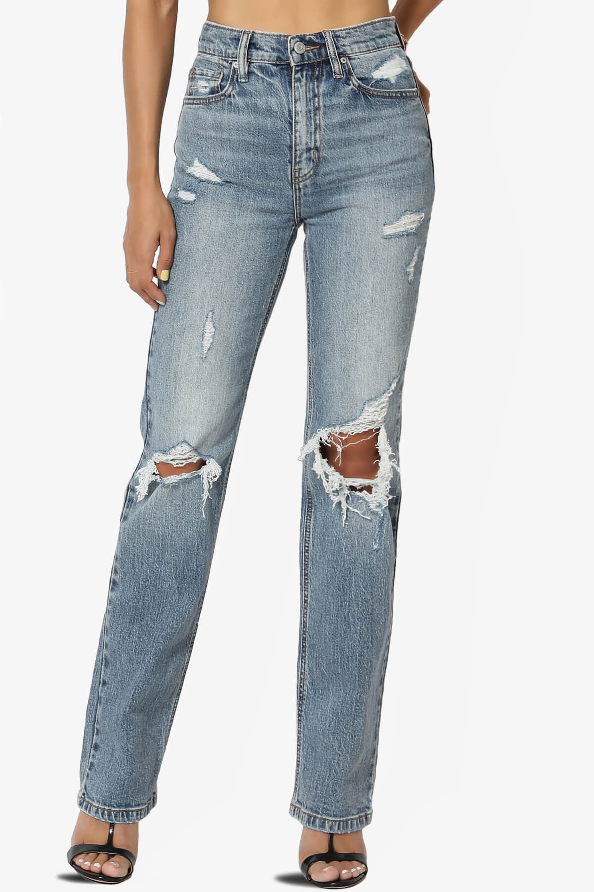 A woman wearing distressed dad jeans
