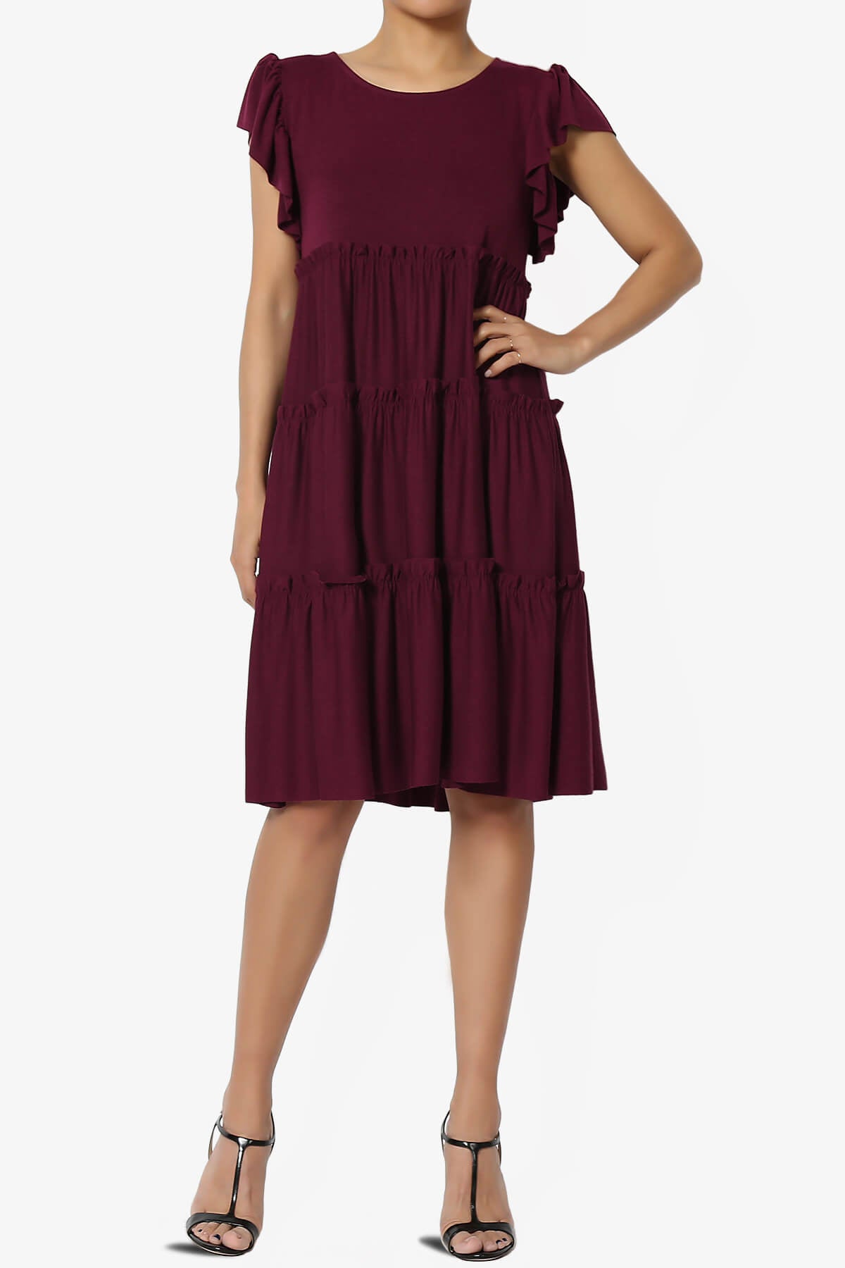 A woman wearing a burgundy ruffle dress 