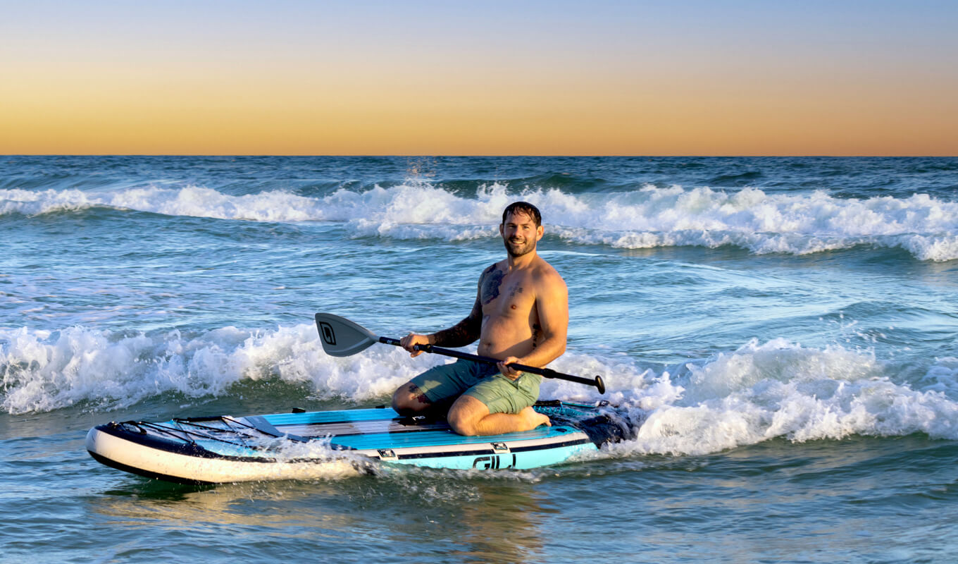 Man riding his inflatable paddle board in Myrtle beach