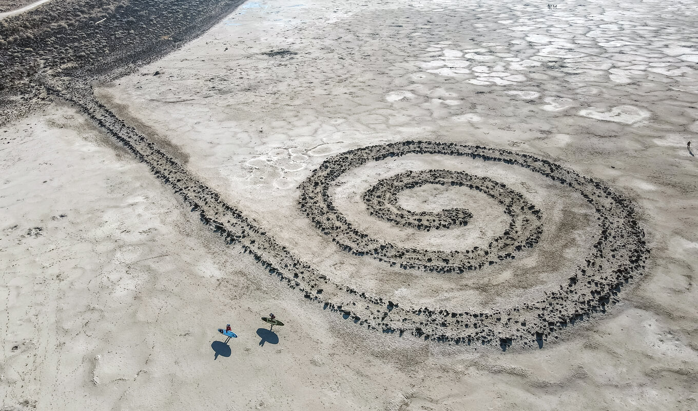 Man and a woman paddle boarding in Spiral Jetty