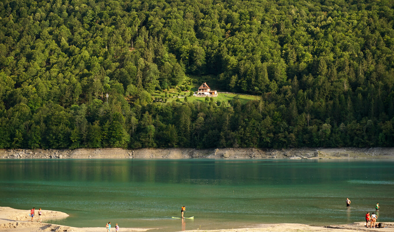 People paddle boarding in Lake Barcis