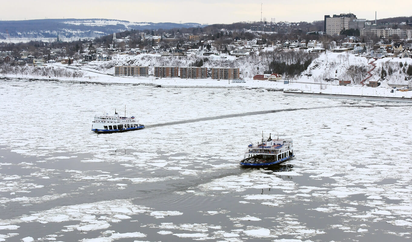 Boats traversing on icy st.lawrence river, Quebec