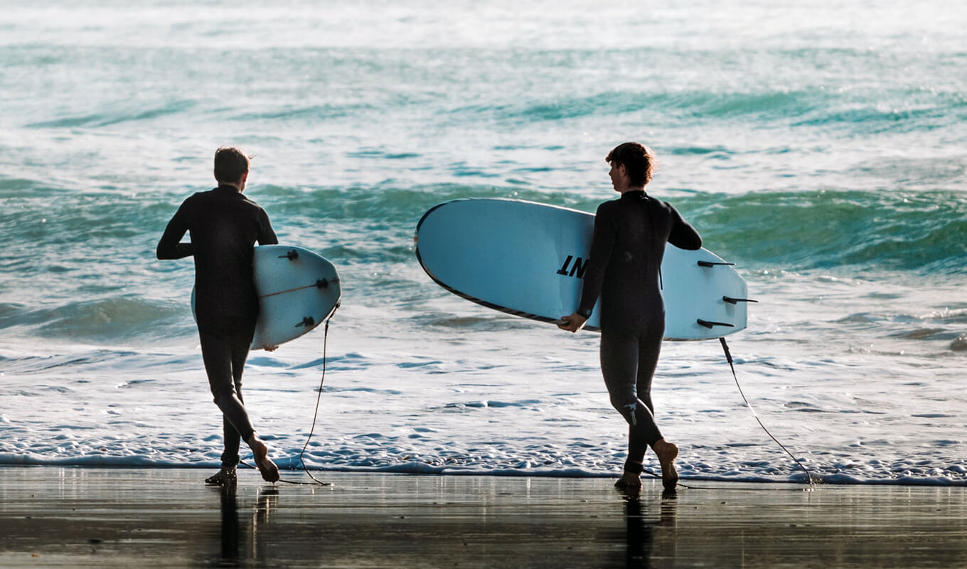 Two surfers of Raglan, New Zealand