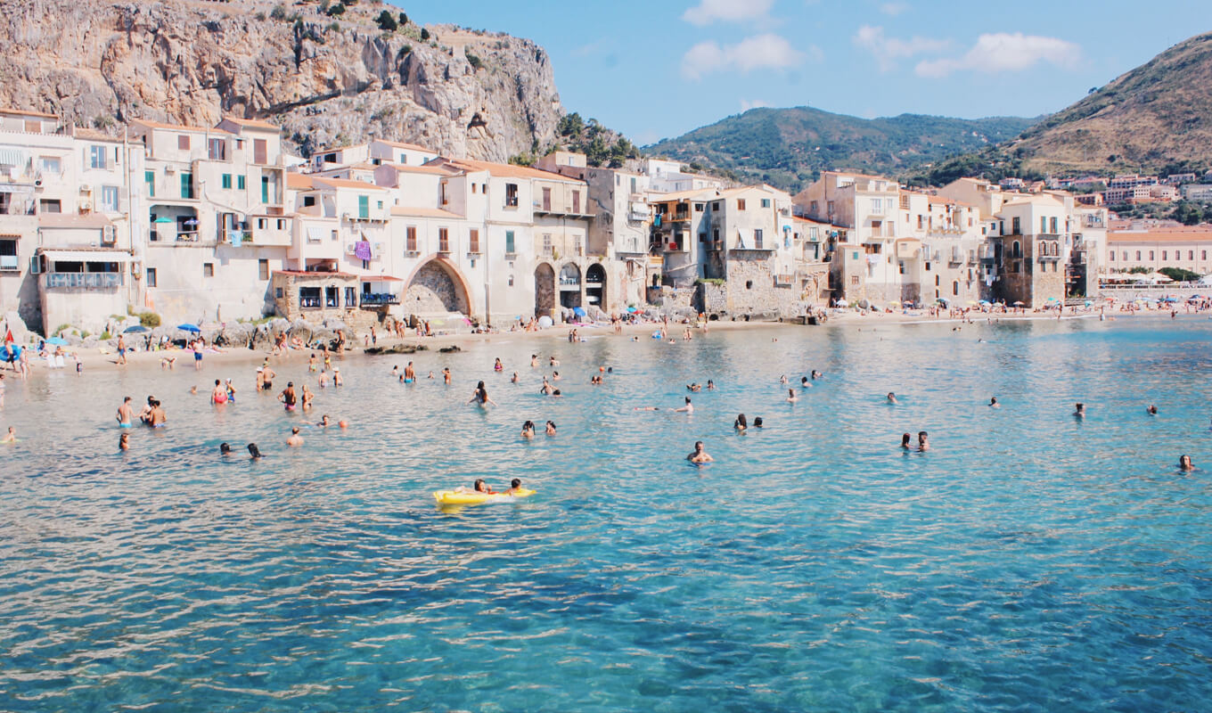 People swimming on Cefalu, Italy