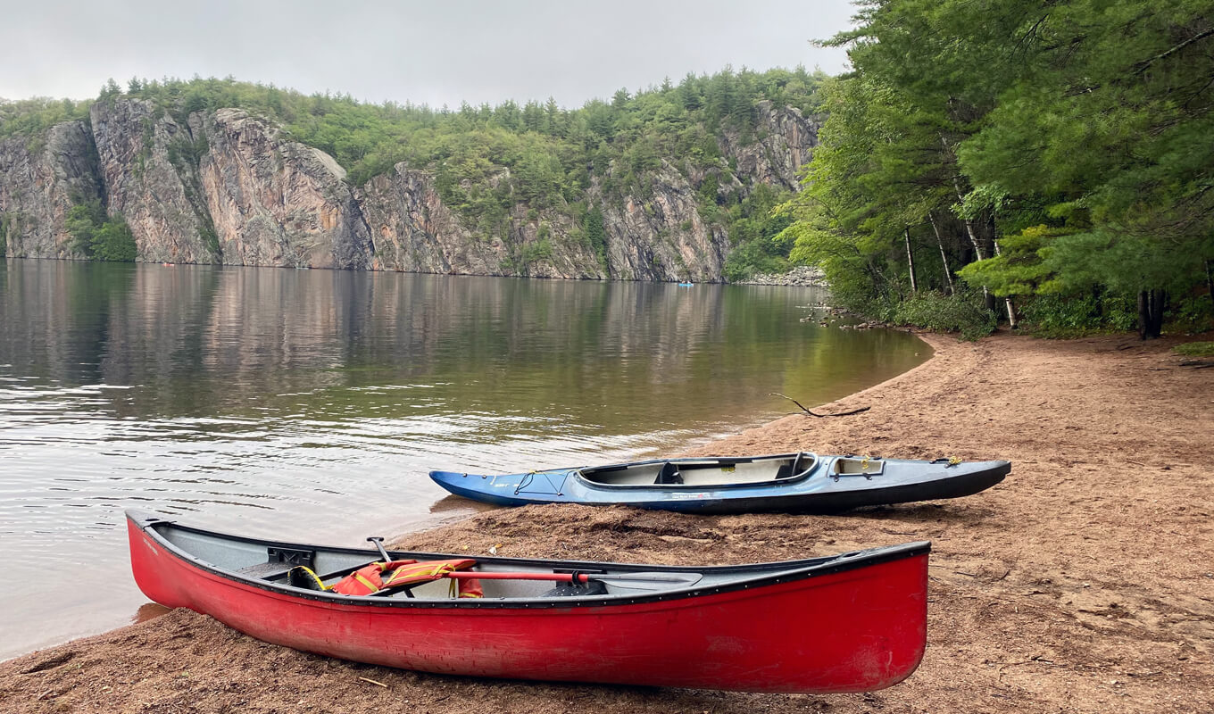 Red and white boat on Mazina Lake in Bon Echo Provincial Park, Ontario Canada