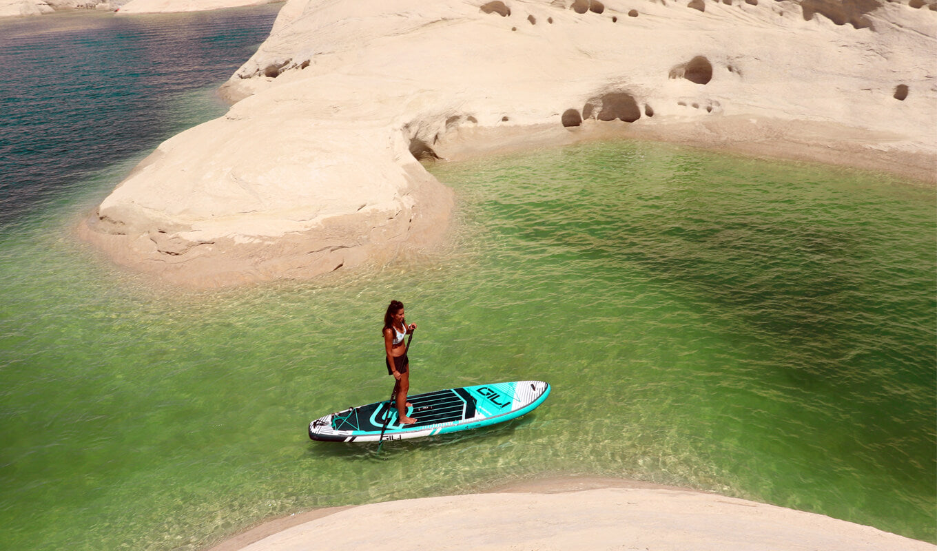 Woman paddle boarding on lake powell