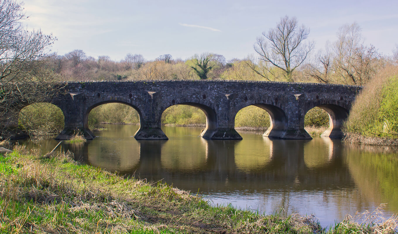 The calm water River Quoile flow under the Quoile bridge