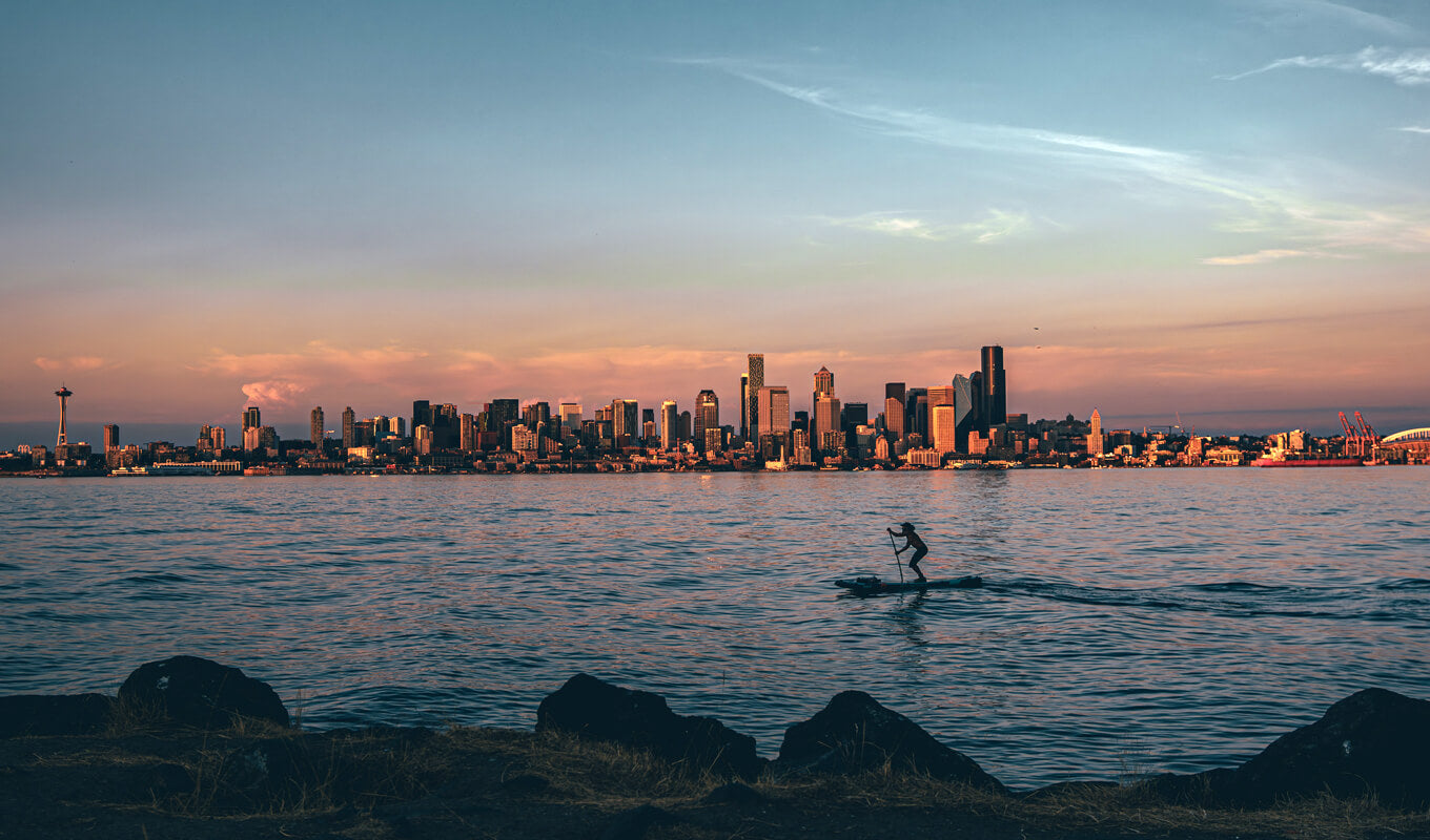 Man paddle boarding on Alki beach, Seattle