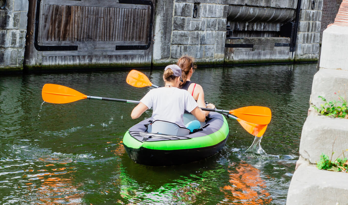 Man and woman on a tandem inflatable kayak