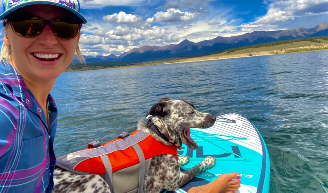 Woman with her dog on a life jacket