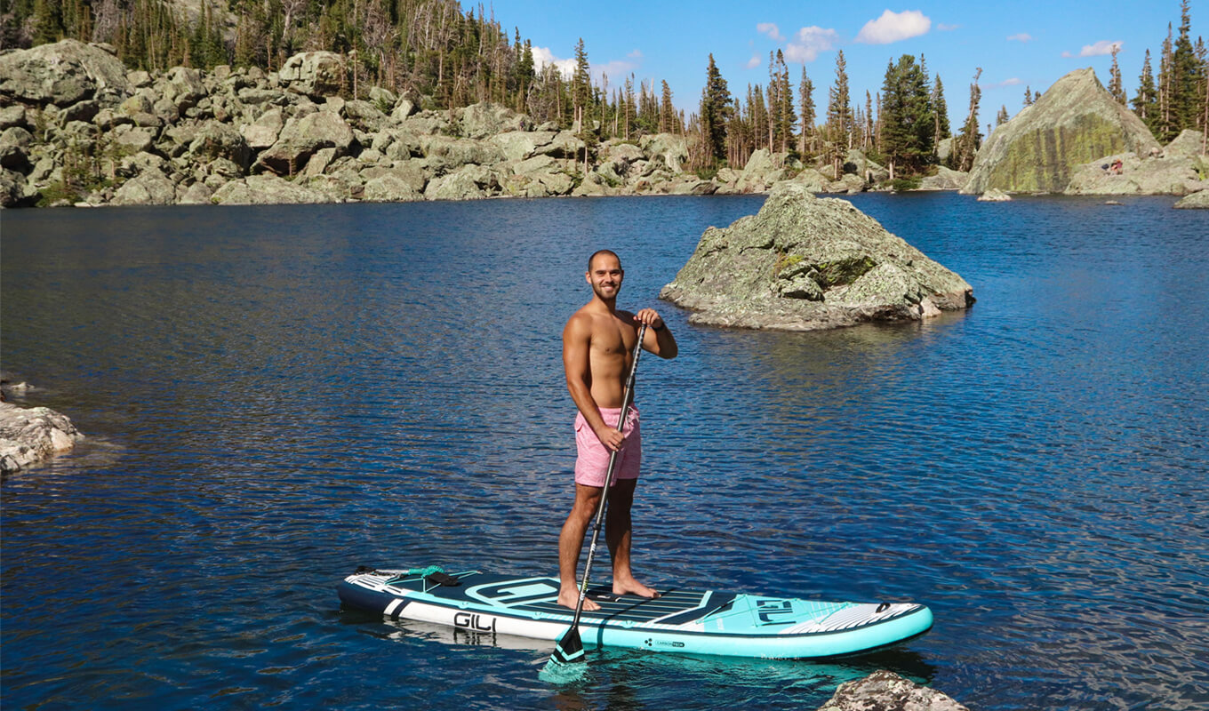 Man paddle boarding on a lake using GILI