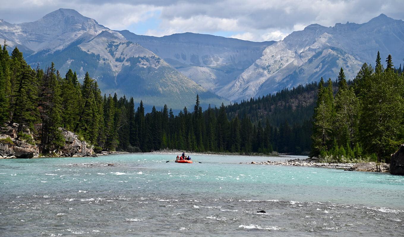 Man on a boat riding the Bow river