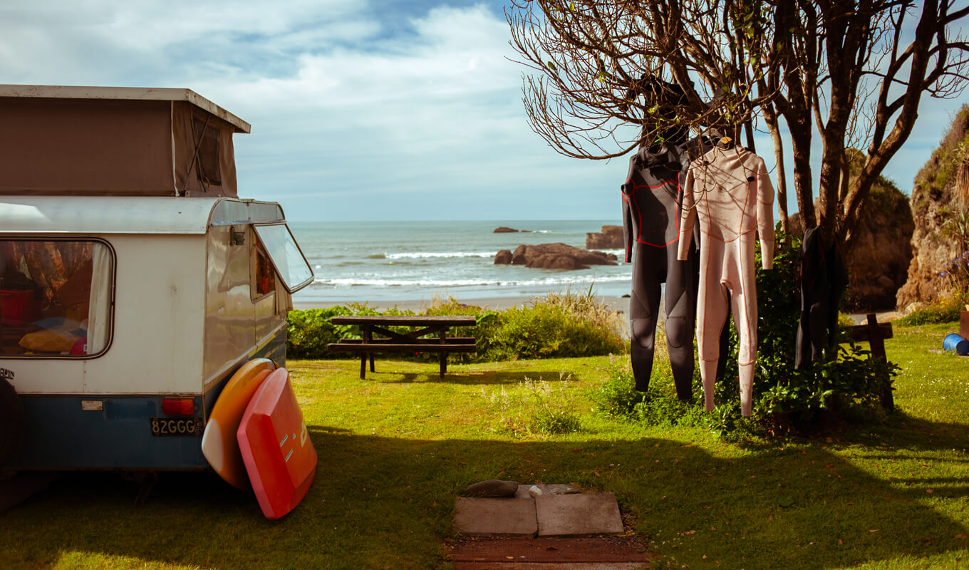 Wetsuits hanging on a tree under the sun