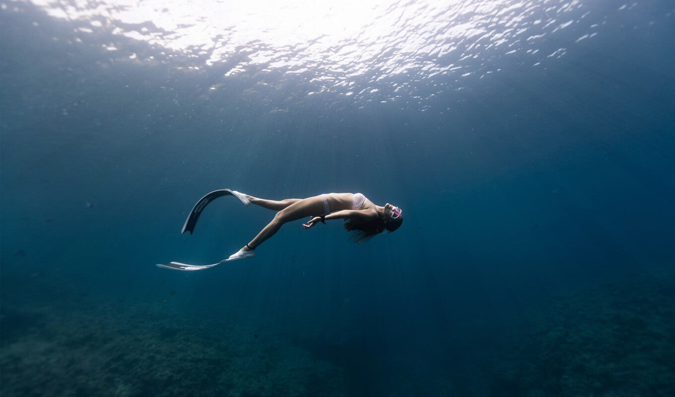 Woman snorkeling at the bottom of the sea