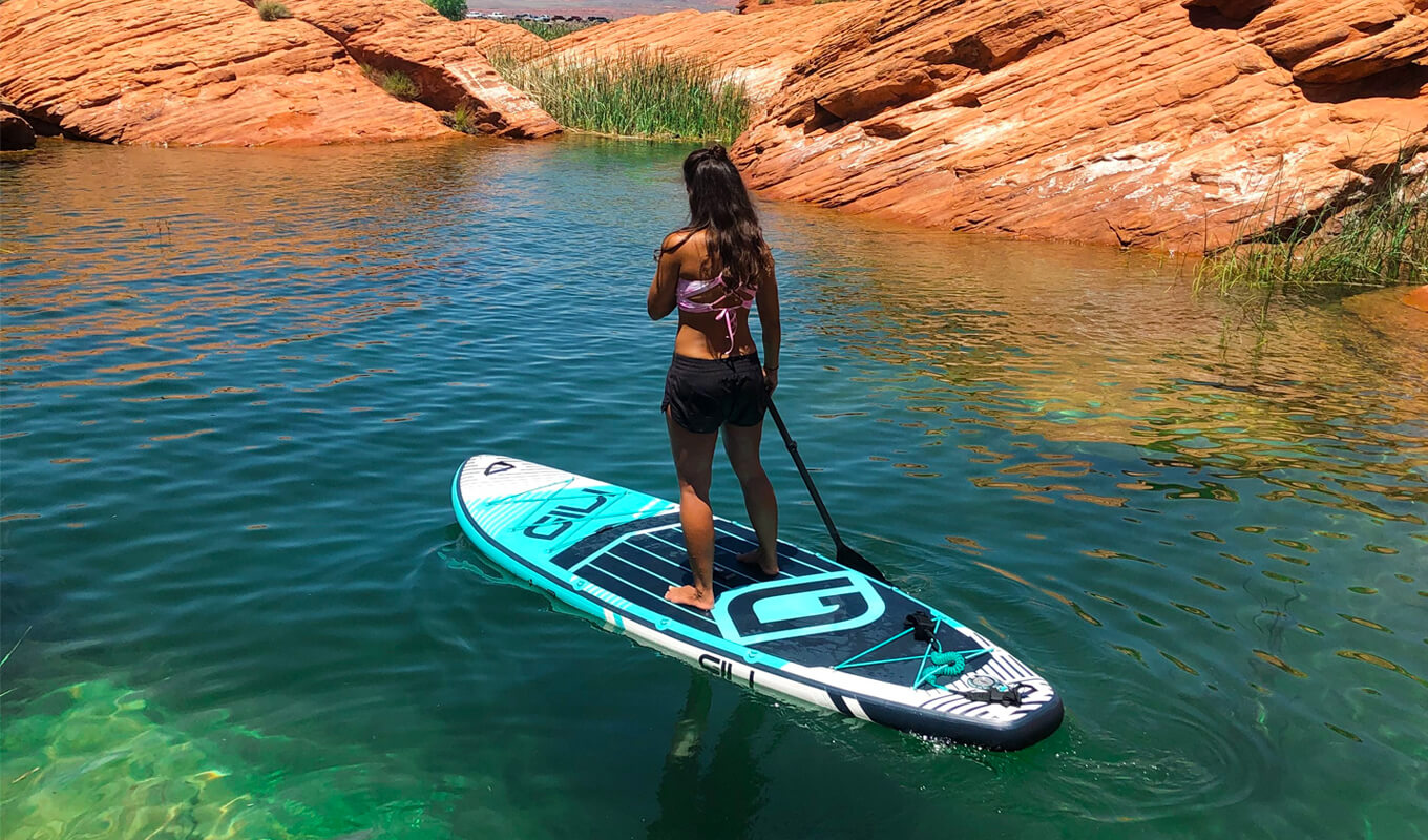 Woman paddle boarding on a clear water