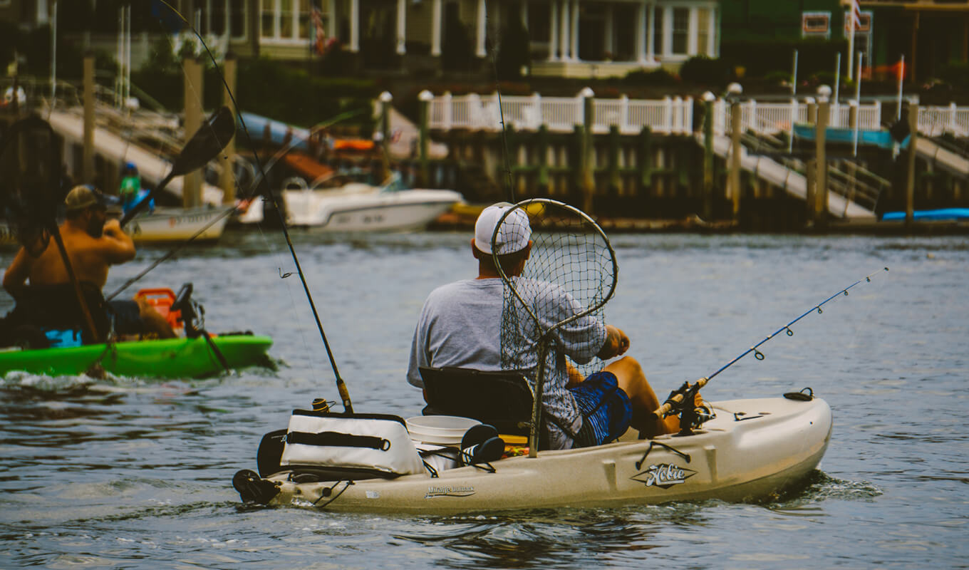 Man fishing on his white kayak