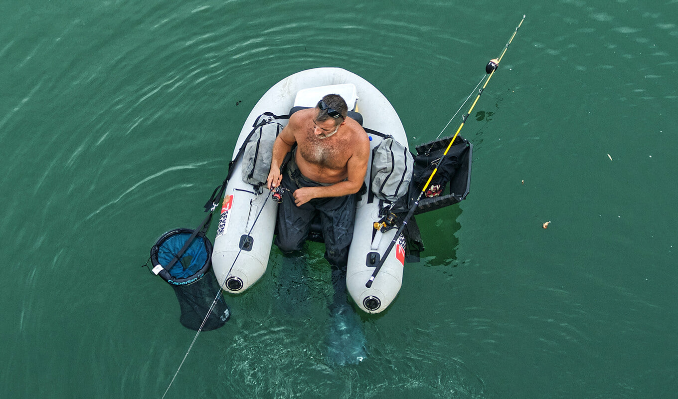 Man fishing on inflatable kayak