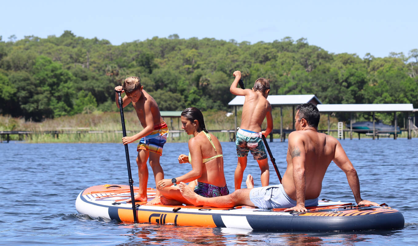 Couple paddle boarding with kids on GILI Manta orange