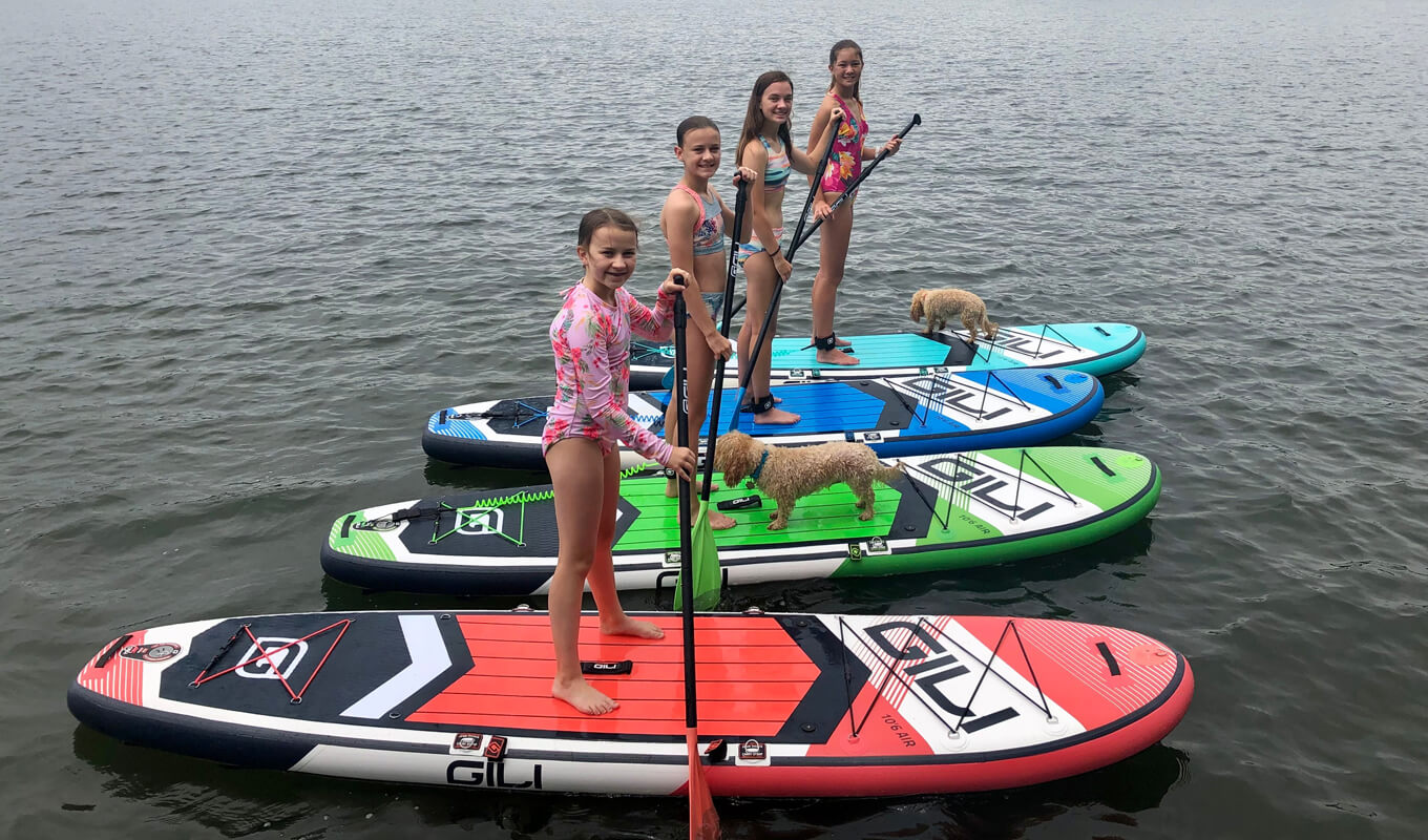 Kids paddle boarding on the lake with GILI SUPs