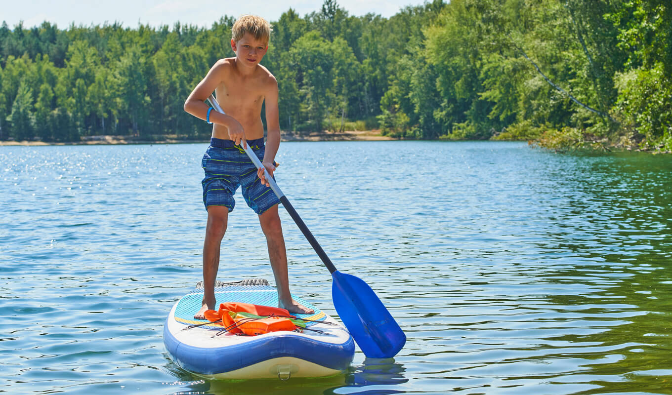 Man paddle boarding at the lake