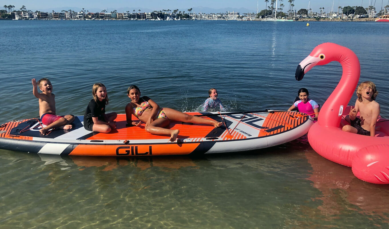 Kids riding on a GILI manta board