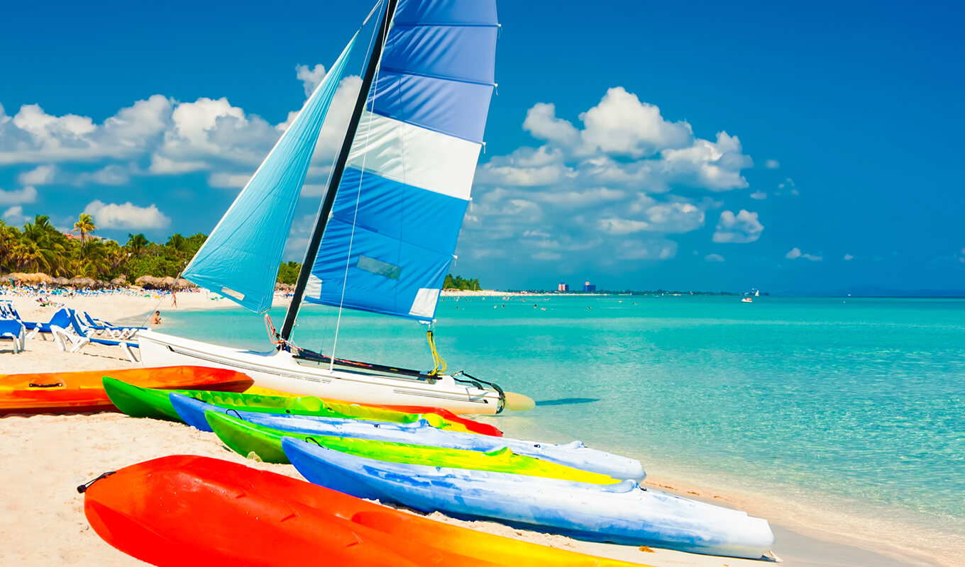 Blue and white sail attach to a white kayak