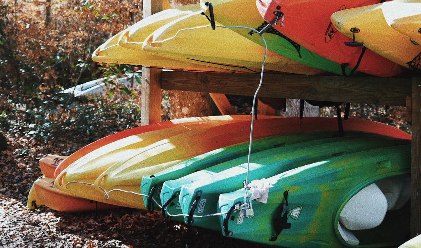 Different kayaks on a rack