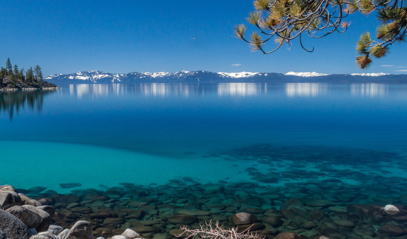 Crystal clear lake with a snow capped mountain