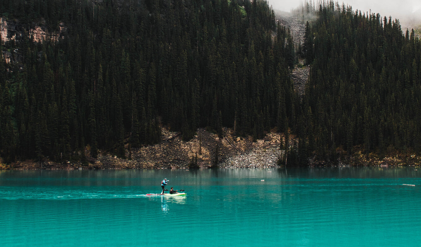 Man paddle boarding in moraine lake alberta