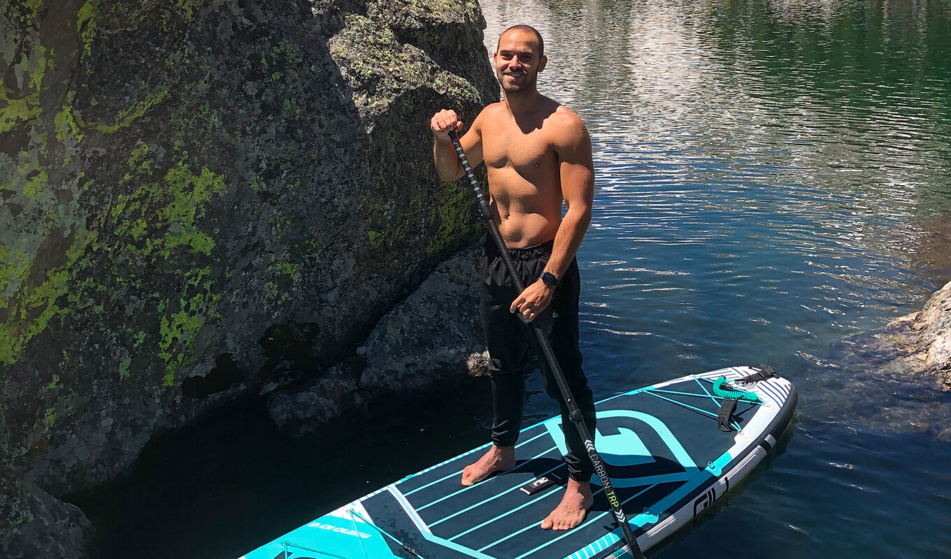 Man paddle boarding while not wearing a leash on a GILI meno