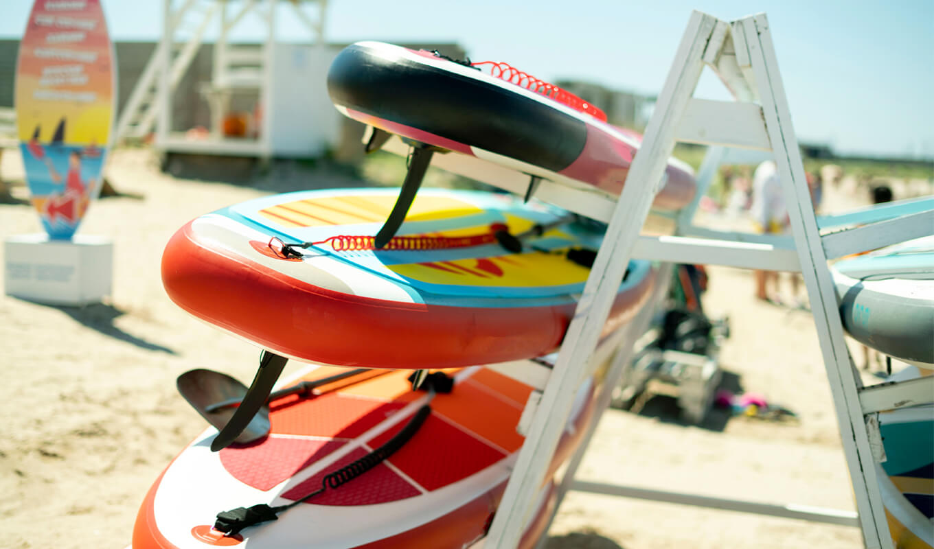 Inflatable paddle boards on a wooden rack