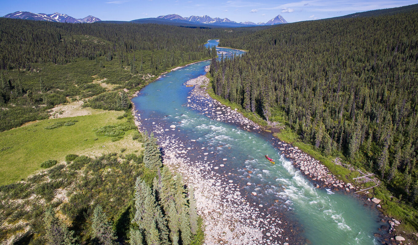 Paddle boarder in south Nahanni river Canada