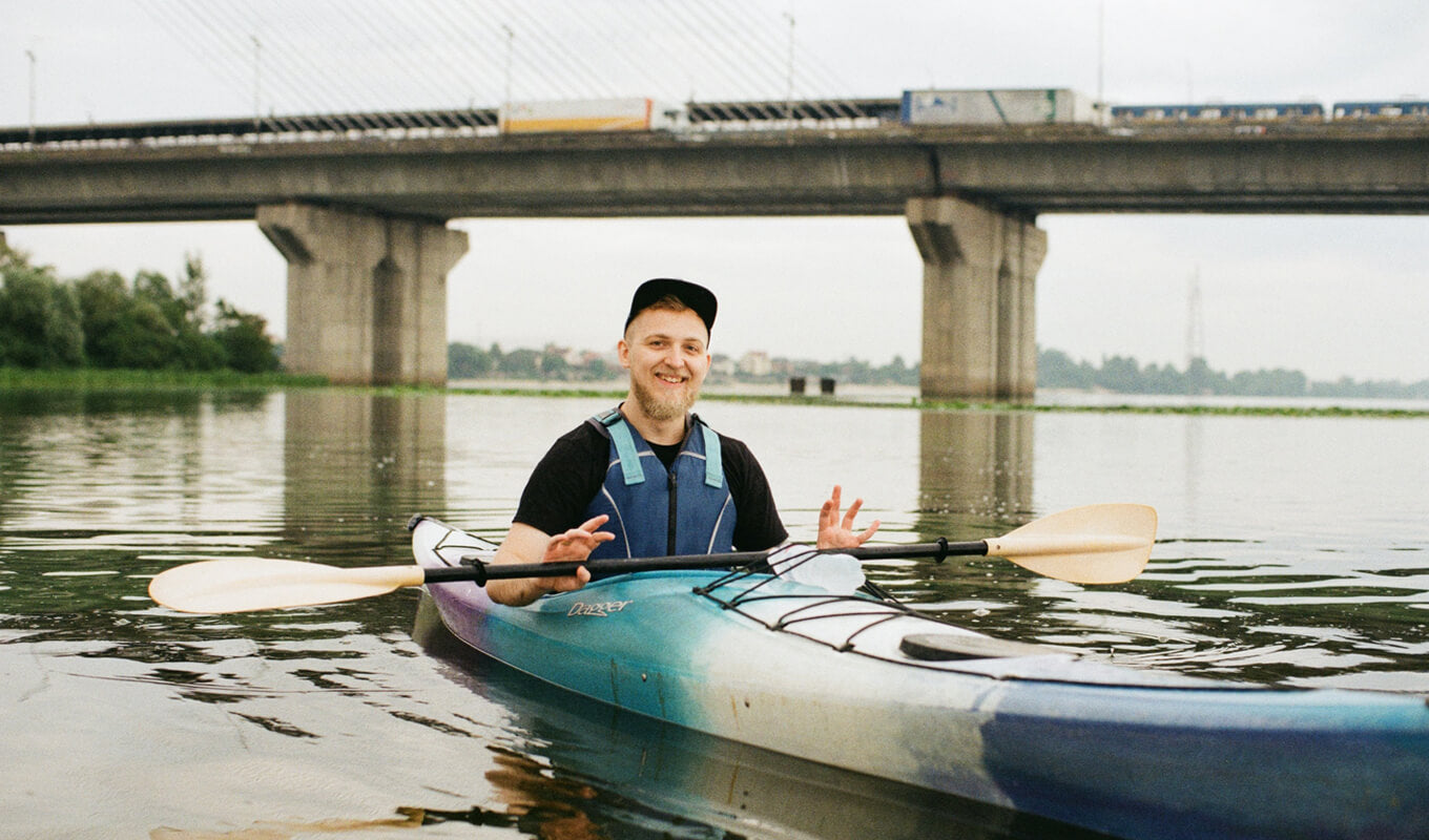 Man wearing a blue life jacket on a sit inside kayak