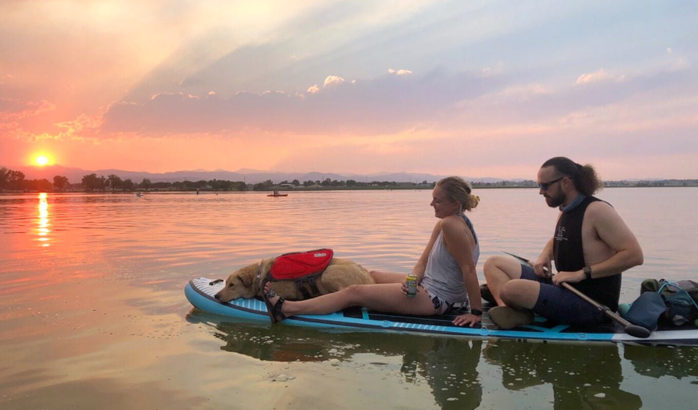 Man and a woman with their dog on a GILI sup